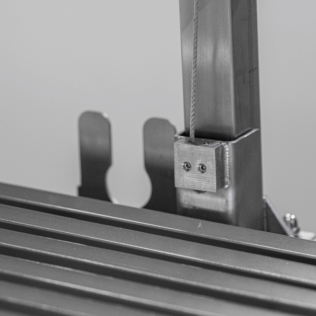 Close-up of a metal bracket on a piece of machinery with a blurred background