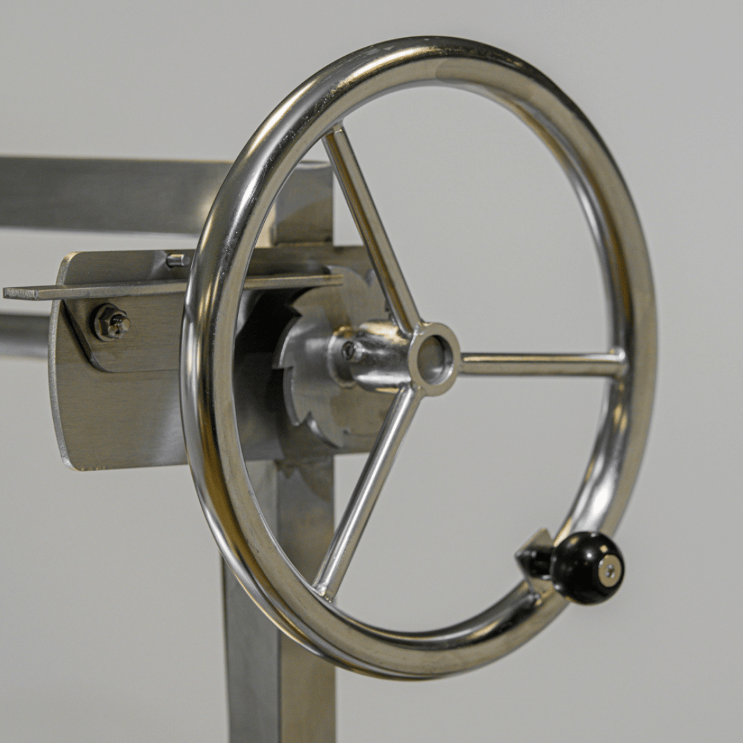 Close-up of a metallic steering wheel for Omberg Asado Gauchos adjustable steel grate
