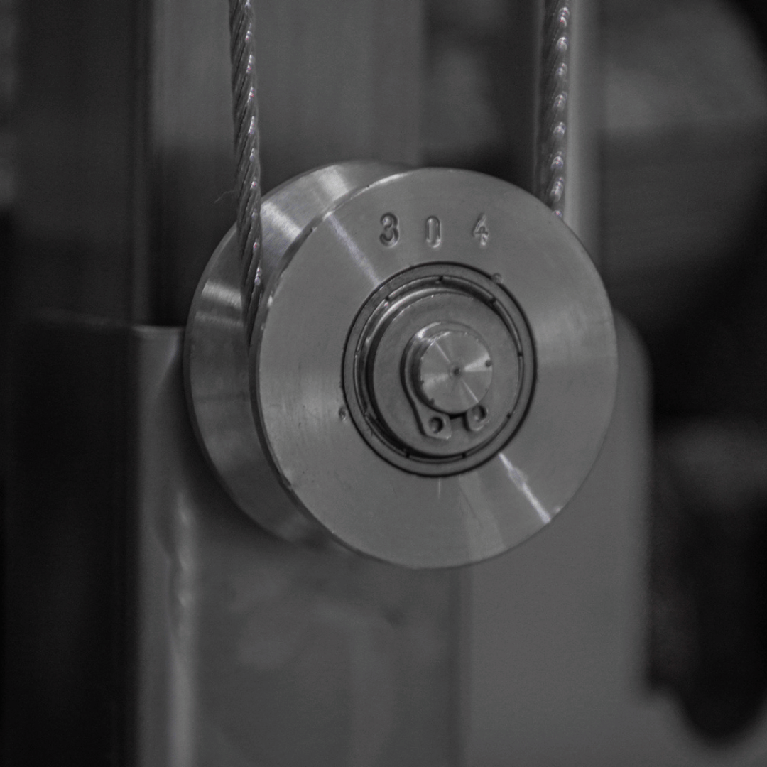 Close-up of a metal pulley system with visible branding.