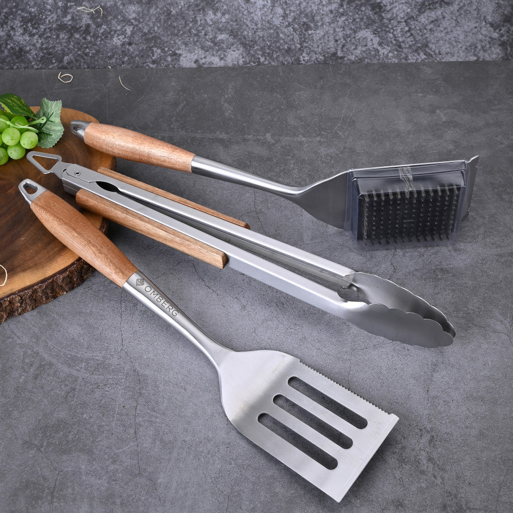 BBQ tool set with brush, spatula, and tongs.