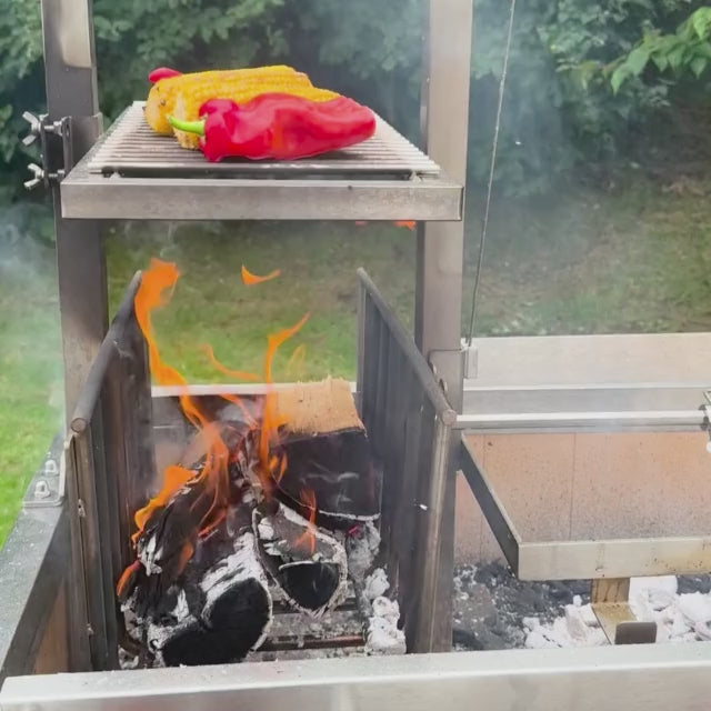 Video of the Omberg Asado Gaucho 1200 being used by a happy customer, with paprika and corn on the brassero shelf, and chicken being rosted using the rotisserie. 